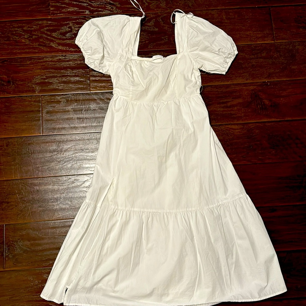 White ASTR dress with slit on the right.